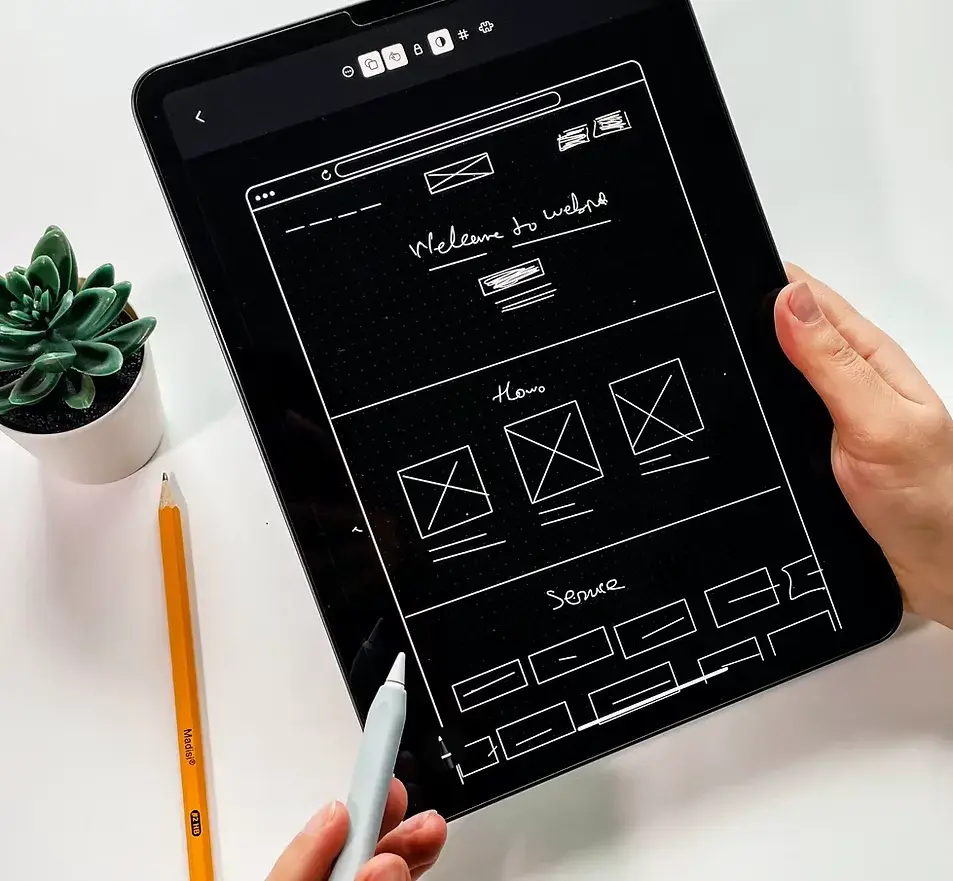 Website wireframe sketched on a tablet
